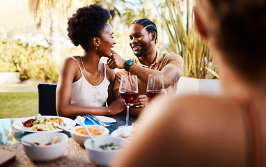 Image showing Outdoor lunch, friends and happy black couple, woman and man wipe, cleaning and remove food from African girlfriend. Together, reunion and people bonding, smile and enjoy meal, buffet or brunch