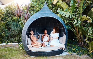 Image showing Travel, luxury and happy women on vacation talking in a conversation or friends on an outdoor getaway together. Wine, laughing and people on holiday in nature bonding in happiness in a modern tent