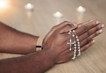 Image showing Rosary, man hand and cross prayer beads in a home with hope, christian praise and religion. Praying, necklace and worship in a house with god, gratitude and spiritual guide for support and healing