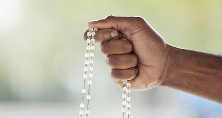 Image showing Rosary, person hand and prayer beads in a home with hop, christian praise and religion. Praying, necklace and worship in a house with hope, gratitude and spiritual guide for support and healing