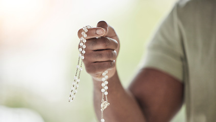 Image showing Rosary, man hands and prayer beads in a home with hop, christian praise and religion. Praying, necklace and worship in a house with hope, gratitude and spiritual guide for faith support and healing