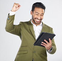 Image showing Business man, winner and success on tablet for stock market, trading news or results, profit and sales in studio. Excited professional person for digital trading with fist and yes on white background