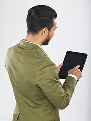 Image showing Back, business and man with a tablet, career and professional on a white studio background. Japanese person, employee and accountant with tech, connection and data analysis with investment or trade