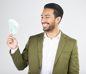 Image showing Happy asian man, money and finance in savings, investment or loan against a white studio background. Excited businessman smile and cash or dollar bills in financial freedom, profit or salary increase