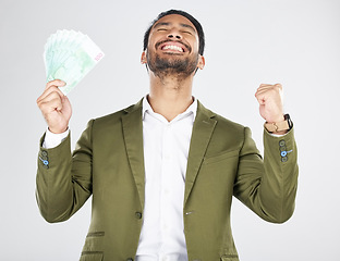 Image showing Money, winner and man with fist celebration in studio for payment, loan or cashback on grey background. Cash, award and Japanese male celebrating investment, growth or financial freedom bingo prize