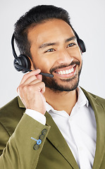 Image showing Happy asian man, call center and headphones in customer service, support or telemarketing against a white studio background. Friendly businessman, consultant or agent smile in online advice or help