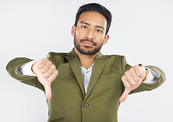 Image showing Portrait, thumbs down and man in studio for wrong, vote or disagreement sign on white background. Face, rejection and Mexican male with emoji hand vote for fail, feedback or opinion, choice or review