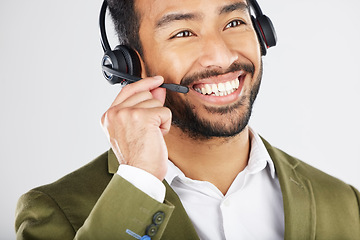 Image showing Happy asian man, call center and headphones in telemarketing, customer service or support against a white studio background. Friendly businessman, consultant or agent smile in online advice or help