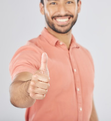 Image showing Happy asian man, portrait and thumbs up in success, winning or good job against a white studio background. Male person smile with like emoji, yes sign or OK in agreement, thank you or approval