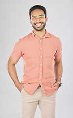 Image showing Happy, fashion and portrait of Asian man in studio smile for confidence, pride and happiness. Confident, attractive and isolated person in casual style, trendy clothes and outfit on white background