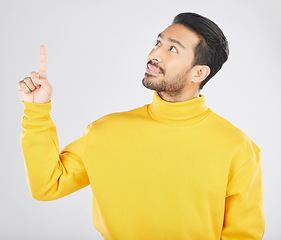 Image showing Announcement, thinking and man pointing for promotion, deal and logo isolated in a studio white background with smile. Choice, offer and happy person or ambassador showing advertising or news