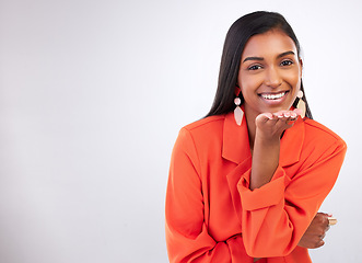 Image showing Smile, portrait and Indian woman blowing kiss in studio for flirting, care or romance gesture on grey background. Happy, face and female model with hand kissing emoji for thank you, gratitude or love