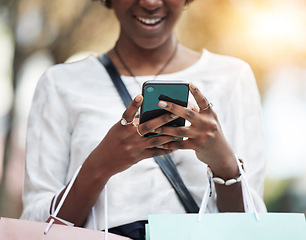 Image showing Woman, outdoor and phone with shopping bag for e commerce, fashion sale and discount news on social media. Student or customer chat on mobile for store reviews, online competition and retail giveaway