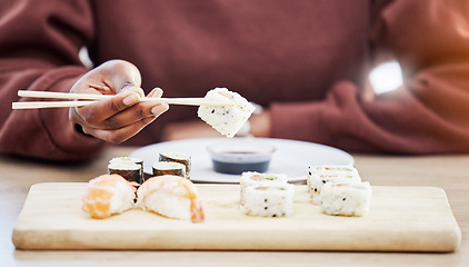 Image showing Sushi, seafood and brunch with hands of person in store for restaurant, Japanese cuisine and menu. Fish, salmon and health with closeup of customer eating for nutrition, Asian diet and fine dining