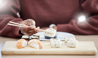 Image showing Sushi, seafood and health with hands of person in store for brunch, Japanese cuisine and menu. Fish, salmon and restaurant with closeup of customer eating for nutrition, Asian diet and fine dining