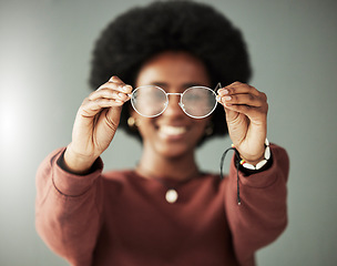 Image showing Hands, woman and closeup of glasses for vision, eyesight and prescription eye care in studio. Person with optical frame, lens choice and eyewear fashion for test, healthcare assessment and optometry