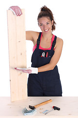 Image showing woman carpenter holding wooden plank 