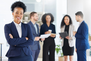 Image showing Crossed arms, leadership and portrait of professional black woman in the office with confidence. Happy, smile and young African female attorney with a team of lawyers for legal project in workplace.