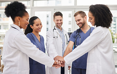 Image showing Doctors, teamwork and hands together in meeting, motivation or unity in healthcare together at hospital. Happy group of medical professionals piling in team building, support or goals at the clinic