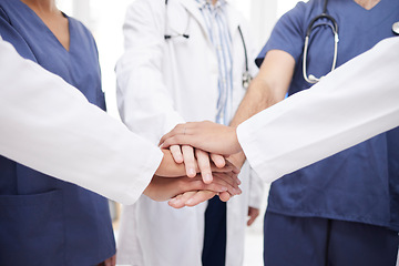 Image showing Doctor, teamwork and hands together in meeting, motivation or unity in healthcare mission together at hospital. Closeup of professional medical group piling in team building, support or clinic goals