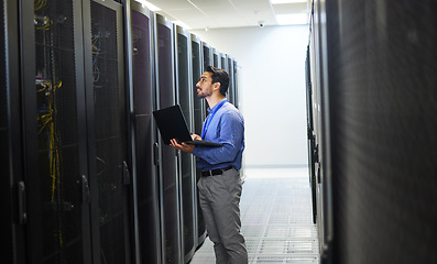 Image showing Man, engineering laptop and server room, data center inspection or system solution for cybersecurity coding. IT person on computer for cables check, business power or programming hardware in basement