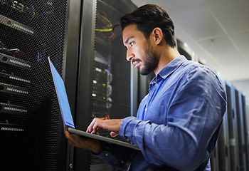 Image showing Connectivity, data center and a man with a laptop for maintenance, cyber security and internet check. Coding, email and an Asian programmer typing on a computer for network or server analytics