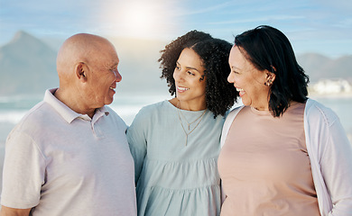 Image showing Happy, beach and woman with her senior parents on a family vacation, holiday or adventure. Love, smile and young female person talking to her elderly mother and father by the ocean on a weekend trip.