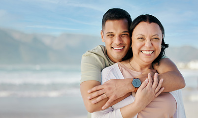 Image showing Hug, portrait and couple at the beach with mockup for a date, vacation or bonding. Smile, care and a man and woman with love on a holiday at the sea with space for travel by the ocean for honeymoon