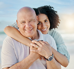 Image showing Beach, portrait and woman with her senior dad on family vacation, holiday or adventure. Happy, smile and young female person hugging her elderly father with love and care by the ocean on weekend trip