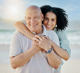 Image showing Beach, portrait and woman with her senior father on a family vacation, holiday or adventure. Happy, smile and young female person embracing her elderly dad with love by the ocean on a weekend trip