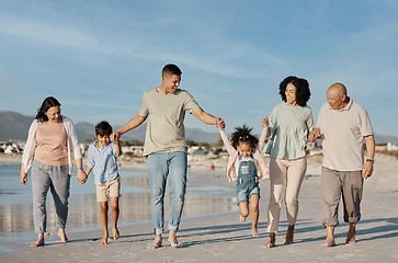 Image showing Walking, happy and family outdoor on a beach with love, care and happiness on travel vacation. Parents, grandparents or men and women holding hands of children for holiday, journey or fun adventure