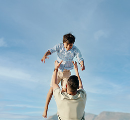 Image showing Dad, son and blue sky, playing together in summer and tropical island holiday on beach in Hawaii. Fun, father and and son on ocean vacation with airplane games to relax, trust and support in nature.