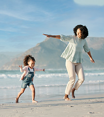 Image showing Mom, child and playing on beach, running together in summer waves on tropical island holiday in Hawaii. Fun, mother and daughter on ocean vacation with airplane games to relax in water with blue sky.