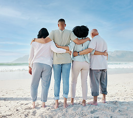 Image showing Back, hug and family at the beach for vacation, ocean view and love in summer. Calm, nature and senior people with a man and woman for care and support in travel at the sea for a holiday together