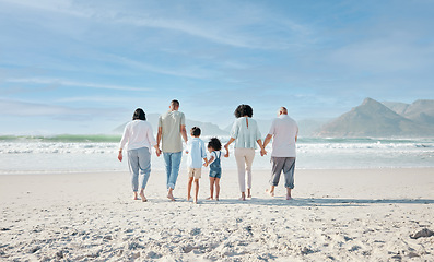 Image showing Family, holding hands and walking outdoor on a beach with love, care and happiness on summer vacation. Behind, space in sky or travel with men, women and children together for holiday adventure