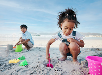 Image showing Boy, girl and shovel with bucket, beach and digging sand with playing, outdoor and vacation in summer. Kids, siblings and plastic toys for sandcastle, construction game and happy for holiday by ocean