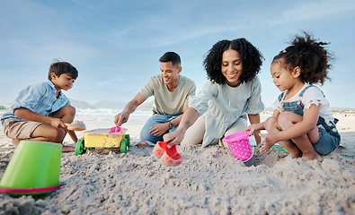 Image showing Parents, kids and sandcastle at beach, bucket and digging for bonding, outdoor and vacation in summer. Mom, dad and siblings with plastic toys, sand or construction game for holiday, happy and ocean