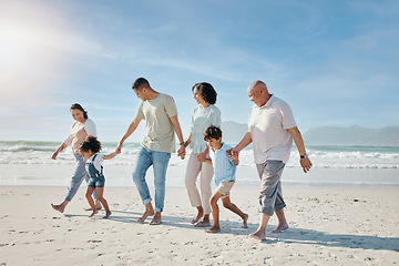 Image showing Family, holding hands and walking outdoor on a beach with love, care and happiness for summer vacation. Parents, grandparents or travel with men, women and children together for holiday adventure