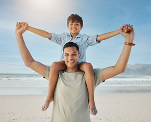 Image showing Portrait of father, child on shoulders and beach, smile together in summer waves on tropical island holiday in Hawaii. Fun, dad and boy on ocean vacation with love, support and relax with blue sky.