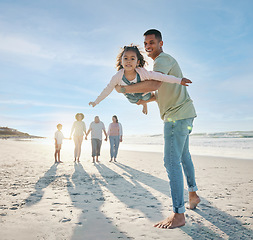 Image showing Dad, girl and family at beach, airplane game and portrait with smile, bonding and love in summer sunshine on vacation. People, father and flying daughter, happy and swinging in air, ocean and holiday