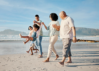 Image showing Walking, holding hands and family with children on a beach with love, care and happiness on travel vacation. Parents, grandparents or men and women with kids outdoor for holiday, journey or adventure