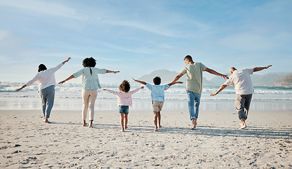Image showing Playing, together and big family on beach, vacation or holiday freedom in summer with children and generations flying. Parents, grandparents and kids play game to fly, airplane for fun and happiness