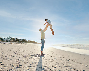 Image showing Father throwing child in air on beach, sunshine and playing together in summer on tropical island holiday. Fun, dad and boy on happy ocean vacation with love, support and relax in blue sky in Hawaii.