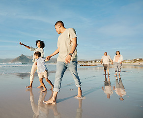 Image showing Big family, holding hands and walking at the beach with conversation, relax and bond on blue sky background. Love, child and parent with grandparent at the ocean for travel, fun and freedom in Bali