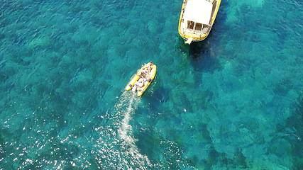 Image showing People on boat from above, sailing in Greece and summer sun on ocean holiday, relax in freedom and nature. Yacht vacation, aerial view of travel and tropical cruise on sea adventure to Greek island.