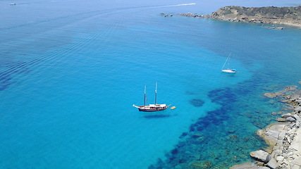 Image showing Aerial of yacht on blue water, sailing in Croatia and summer sun on ocean holiday, relax in freedom and nature seascape. Boat vacation, travel and tropical cruise on sea adventure to island coast.