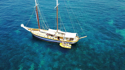 Image showing People on yacht, aerial sailing in Greece and summer sun on ocean holiday, relax in freedom and nature. Boat vacation, family travel and tropical cruise on sea adventure to Greek island on blue water