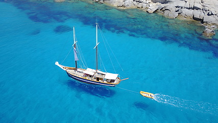 Image showing Yacht, sailing in blue water and summer sun on ocean holiday, relax in freedom and nature. Boat vacation, aerial of travel and tropical cruise on adventure to Greek island with sunshine, fun and sea.