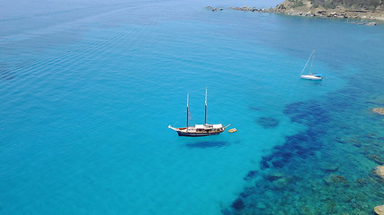 Image showing Boat on blue water, sailing in Croatia and summer sun on ocean holiday, relax in freedom and nature seascape. Yacht vacation, fun travel and tropical cruise on sea adventure to aerial island coast.