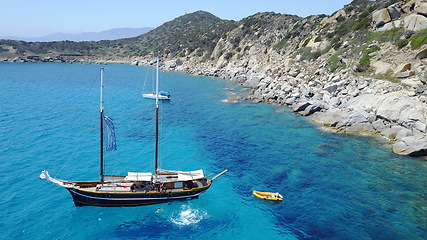Image showing Boat, sailing in Greece and sun on ocean holiday, relax in freedom and nature with clean blue water. Yacht vacation, travel in summer and tropical cruise on fun sea adventure with island beach coast.